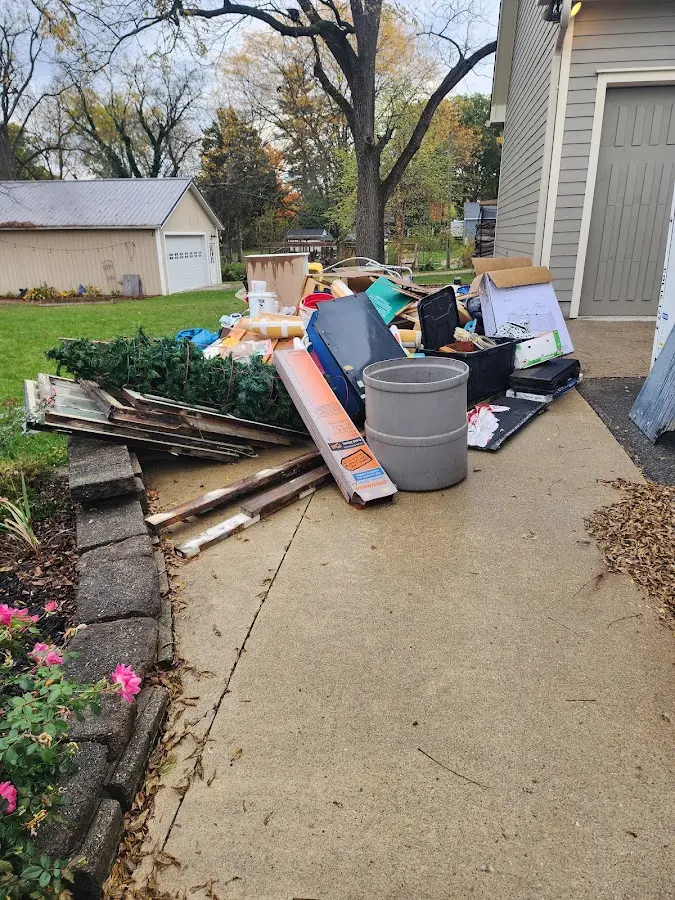 Dumpster being loaded with debris for Estate Cleanout Dumpster Rental in French Island